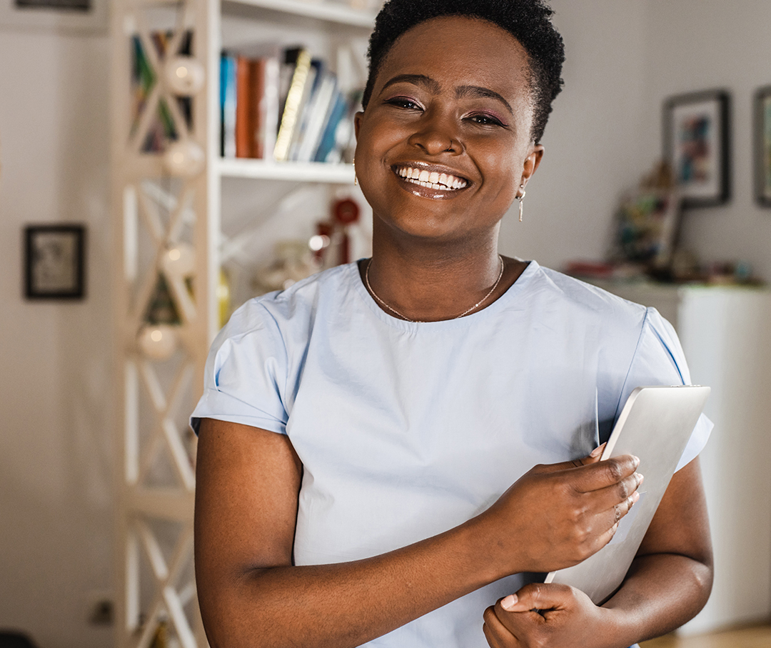 African American woman at home, holding tablet